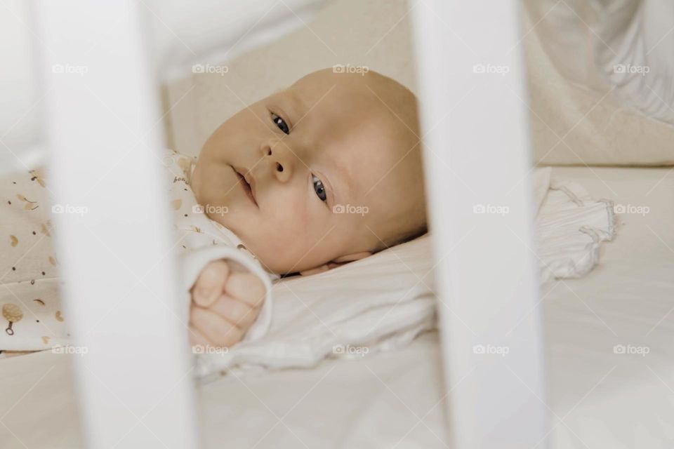 A newborn baby on a yellow and gray background. A photo shoot in the style of Newborn and lifestyle.