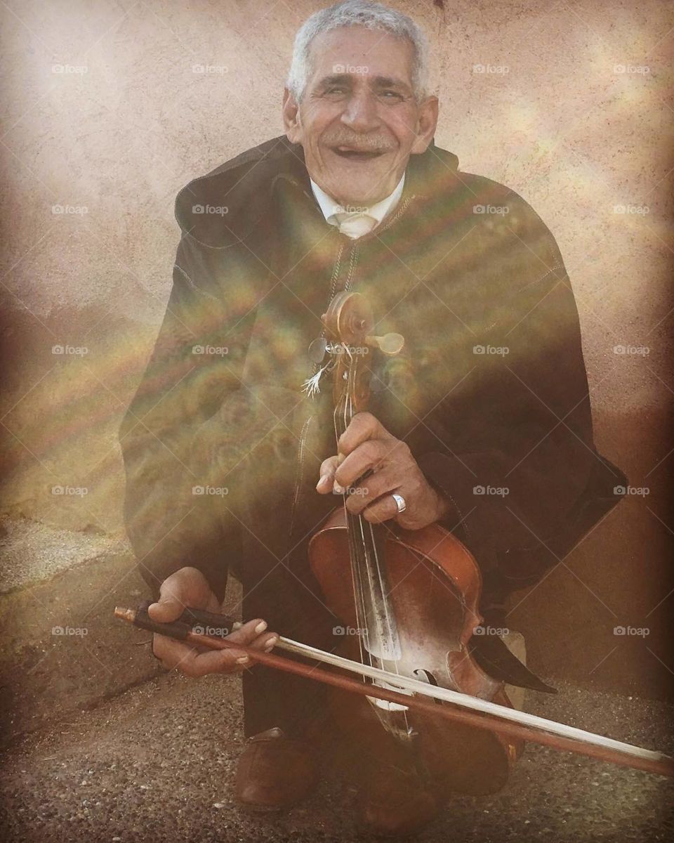happy old man plays the violin