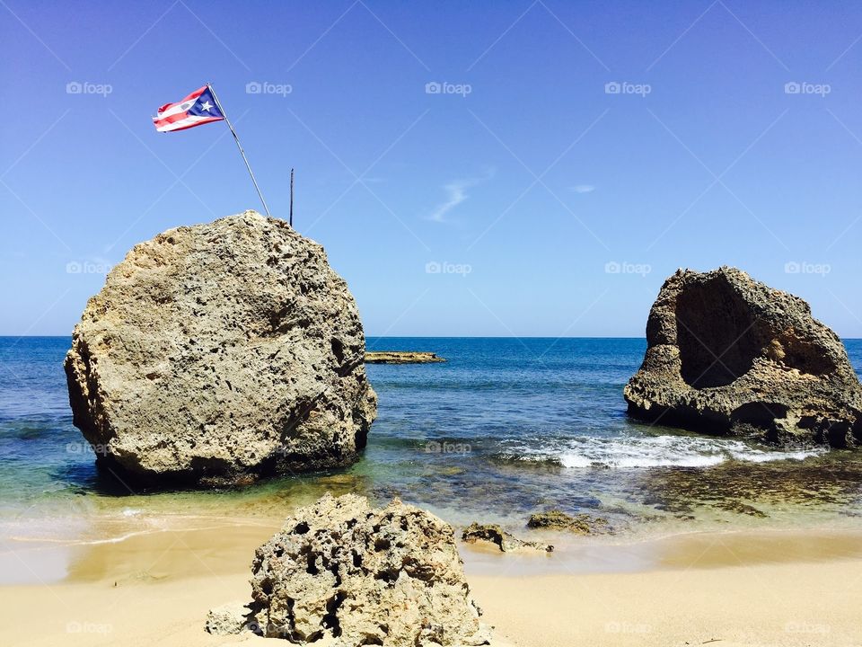Puerto Rican flag in a rock at the beach