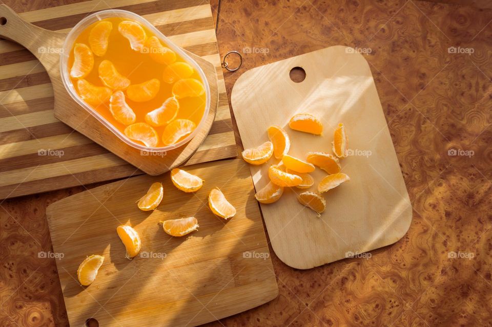 Delicious orange jelly with tangerine slices in a container and jelly worms.