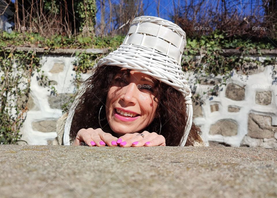 Funny Portrait of Young Woman Posing With Basket on Head, Smiling with Happy Face