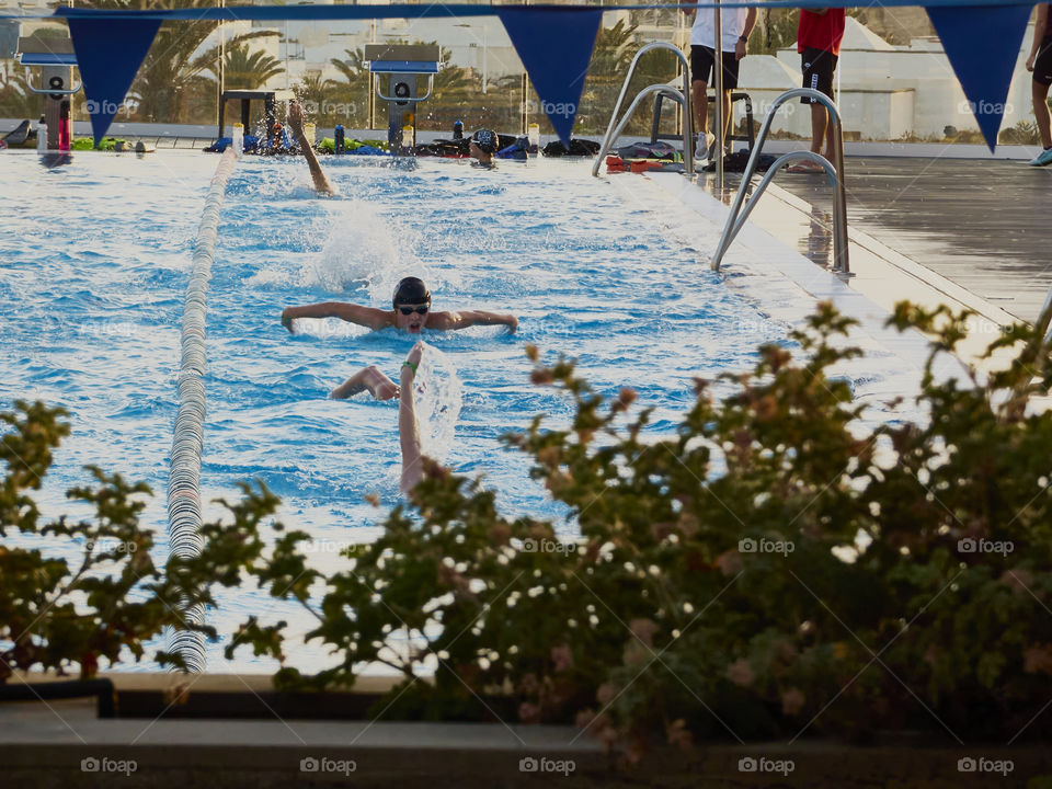 swimming in the olympic pool, in the light of the sunset