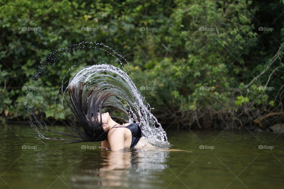 girl squirting water with her hair