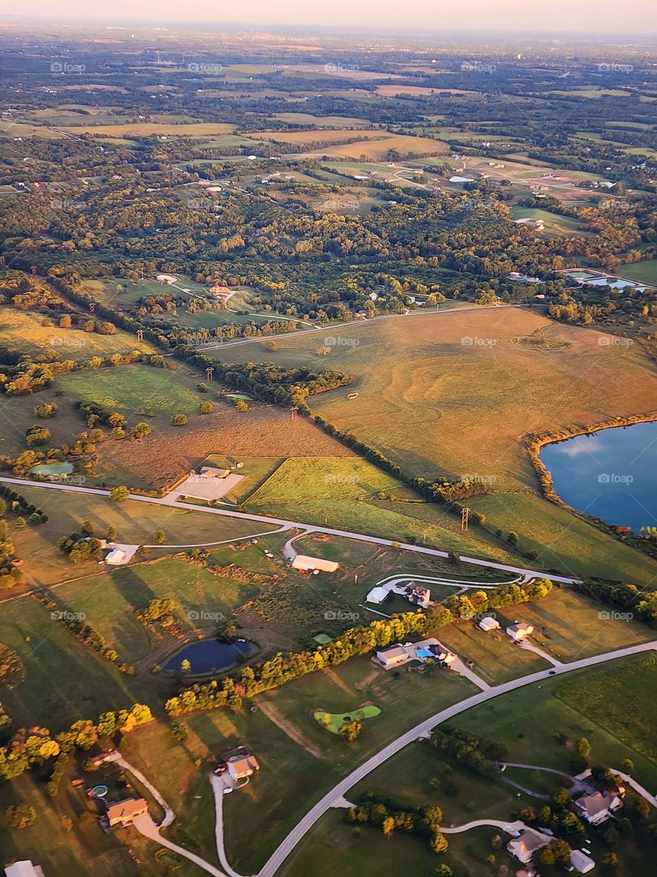 Farmland takes on warm hues as the sun sets on a beautiful summer afternoon in the Midwest
