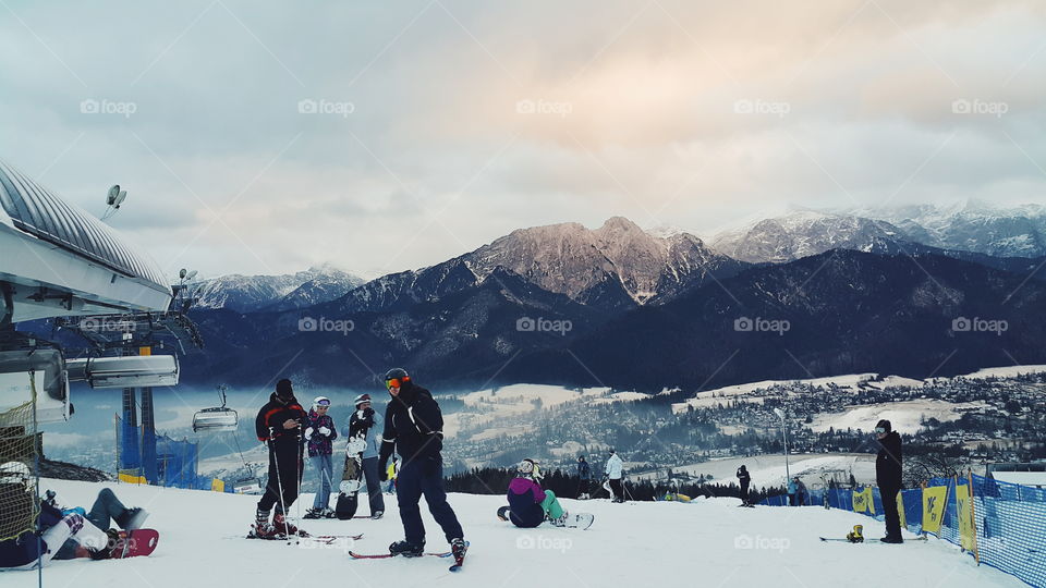 group of people skiing from the snowy hill