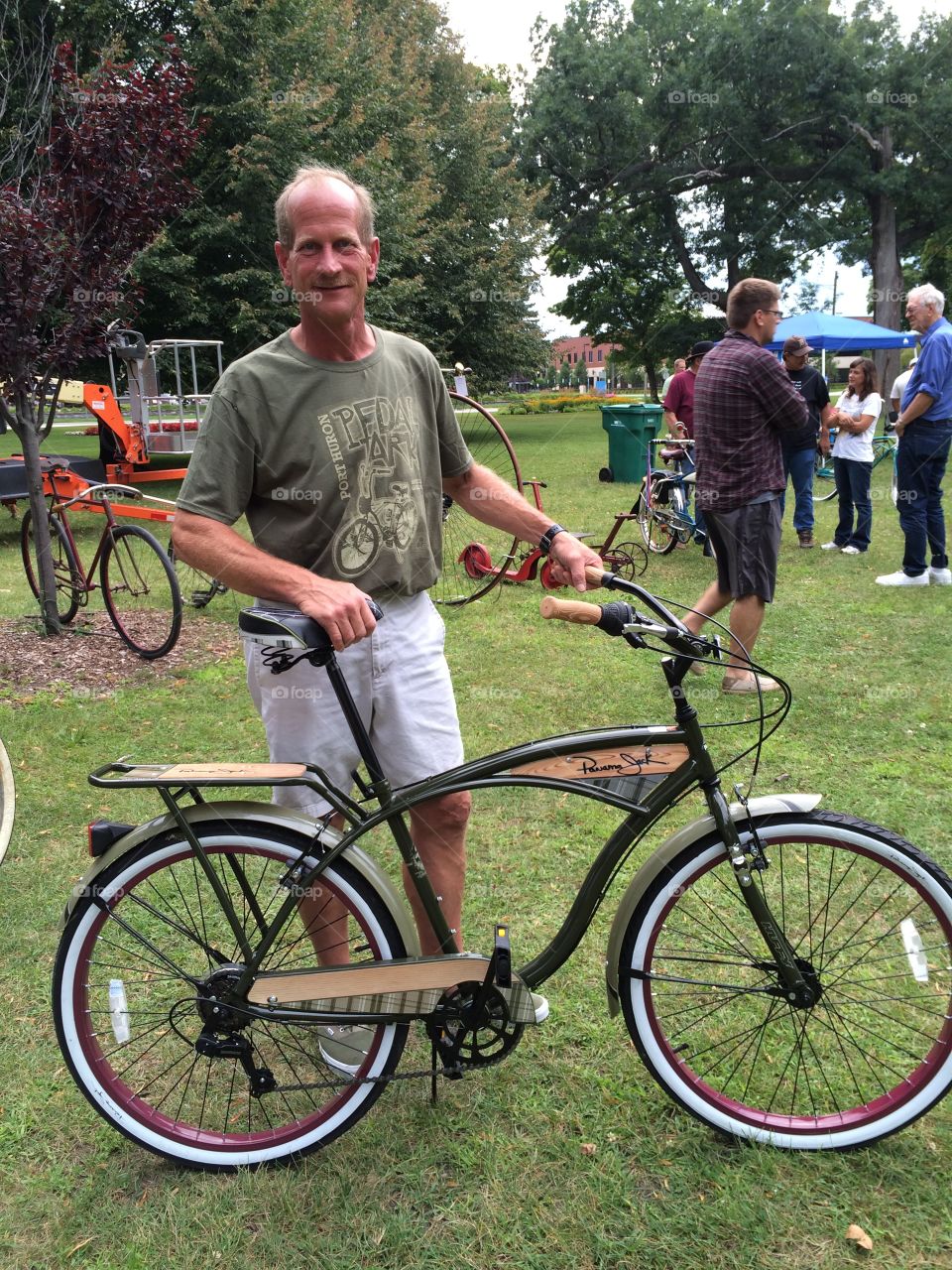 Mature man holding bicycle at park