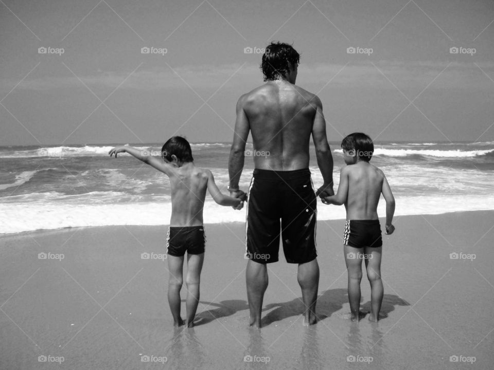 Father and sons at the beach