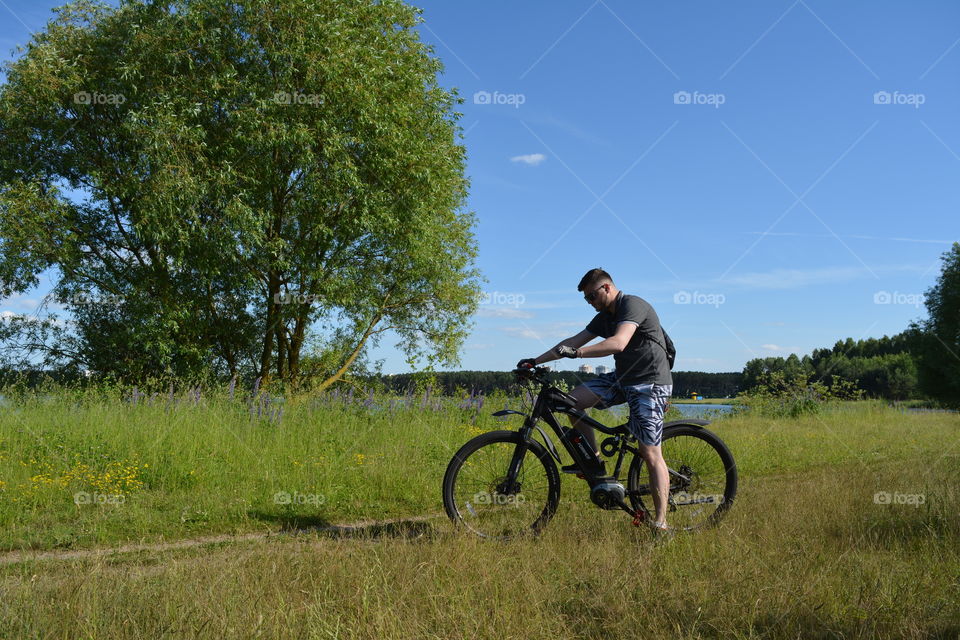 men ridding on a bike summer time