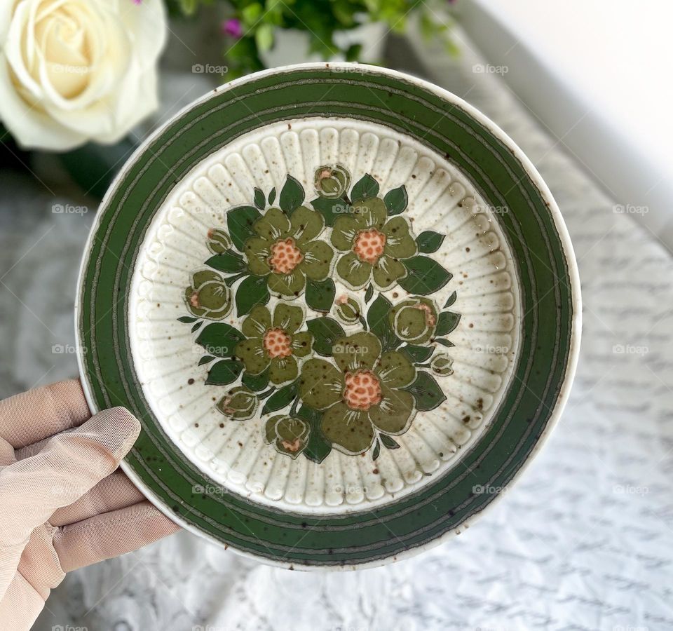 Old green porcelain plates with flowers