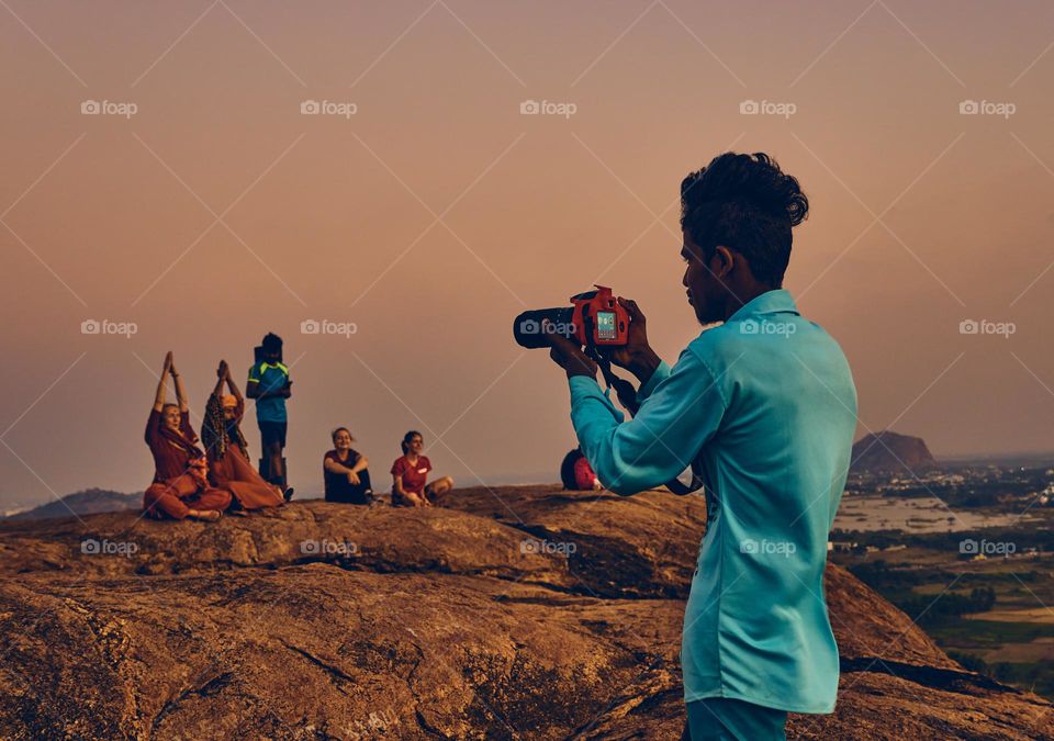 Photographer - Taking a photo on top of a hill 