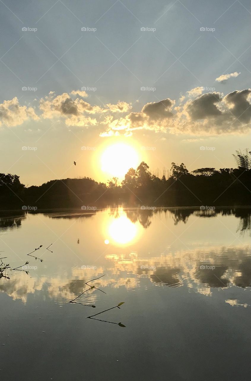 Sun sunset mirrored on the lake