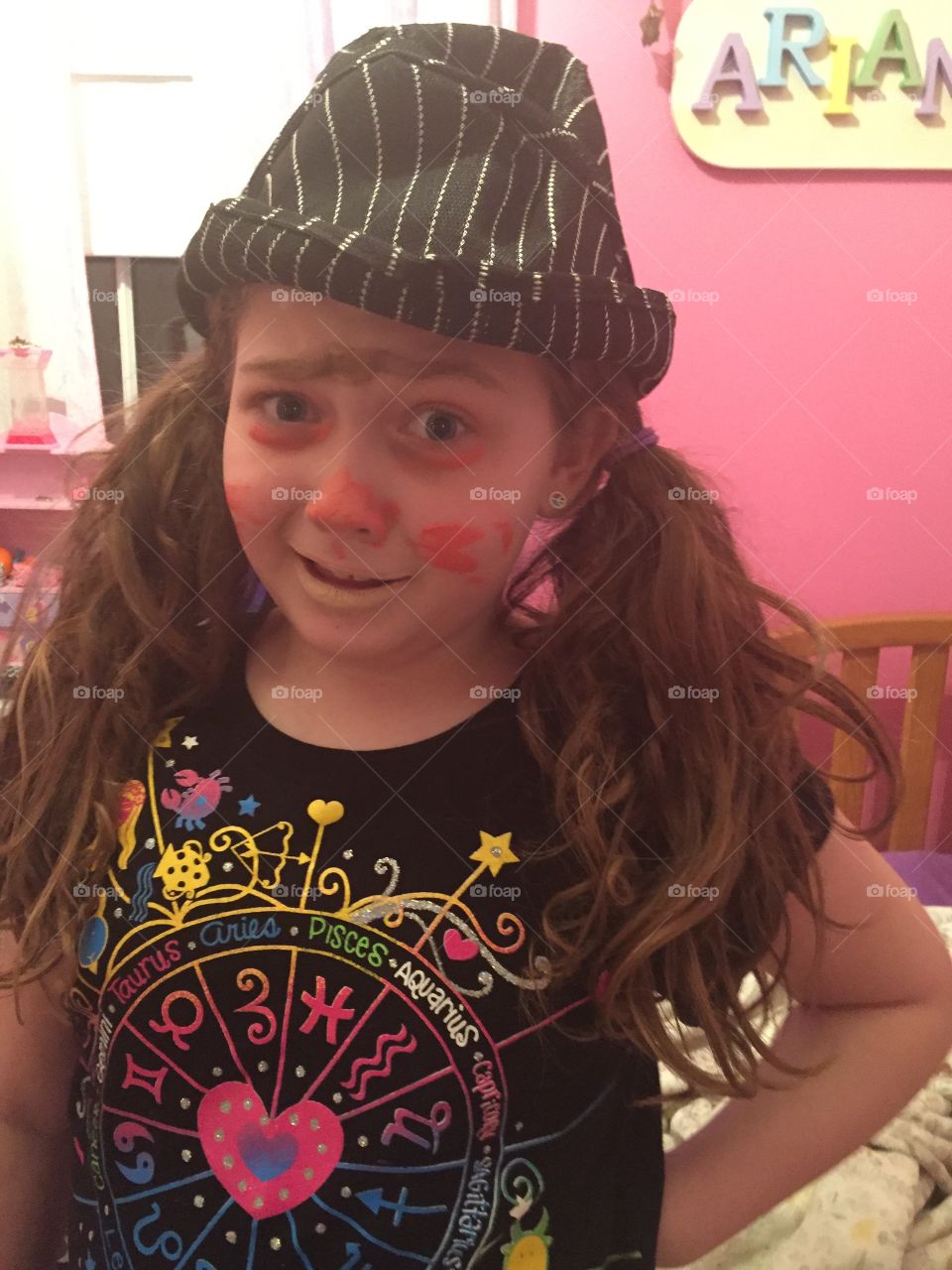 Portrait of little girl with painted face posing