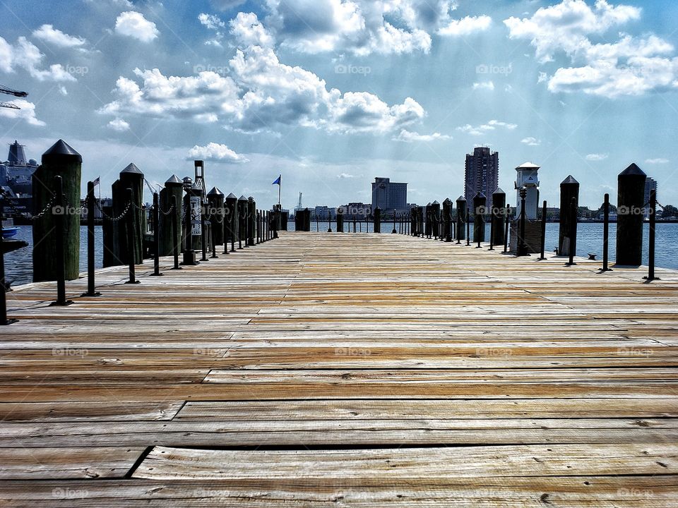 Wooden pier with distant rain clouds