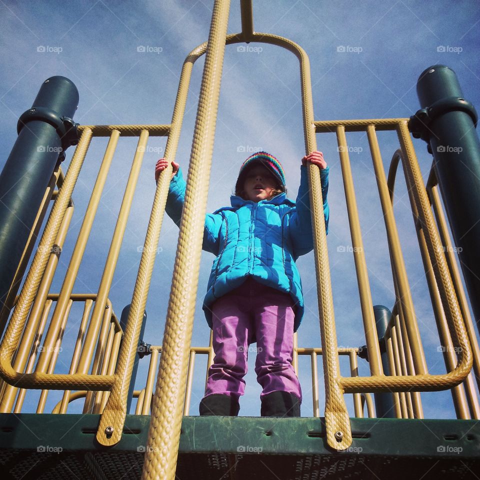 Girl on Playground. Winter doesn't mean staying inside all the time. Sometimes a kid just has to be outdoors! 