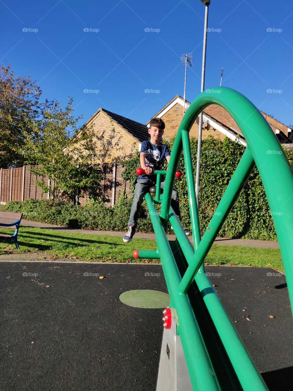 Boy smiling on the see-saw