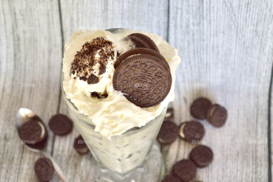 Oreo cookie milkshake with a wooden rustic white background