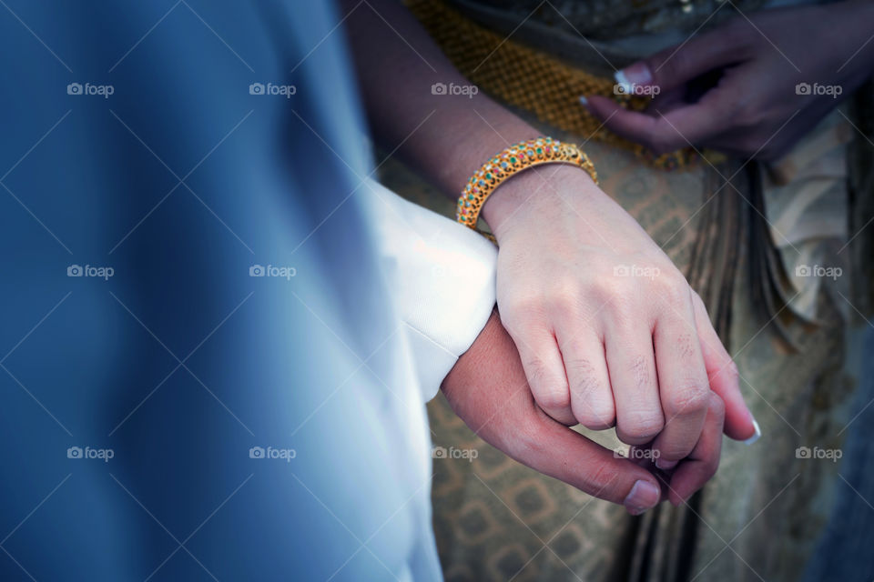 Close-up of couple holding hands