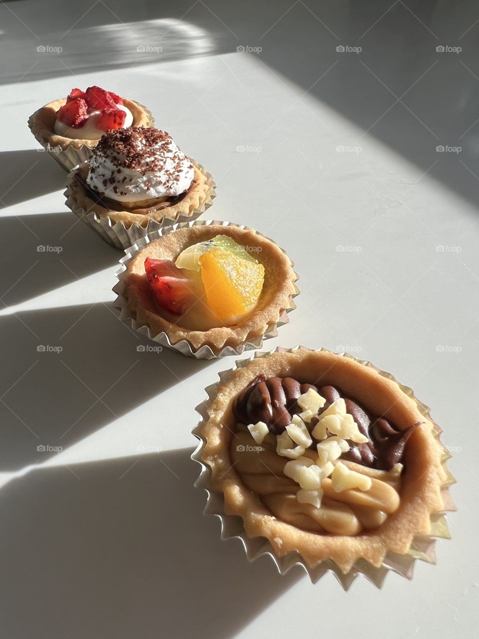 Assorted homebaked Fruit tarts and Nutella chocolate nut butter tarts 