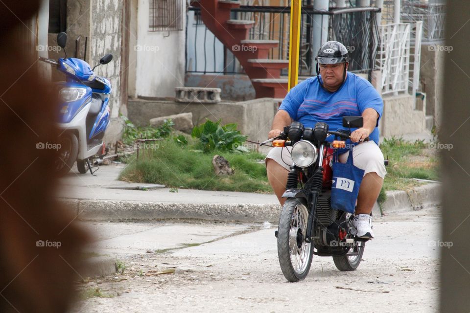 Cuban People.Fat man on a bike