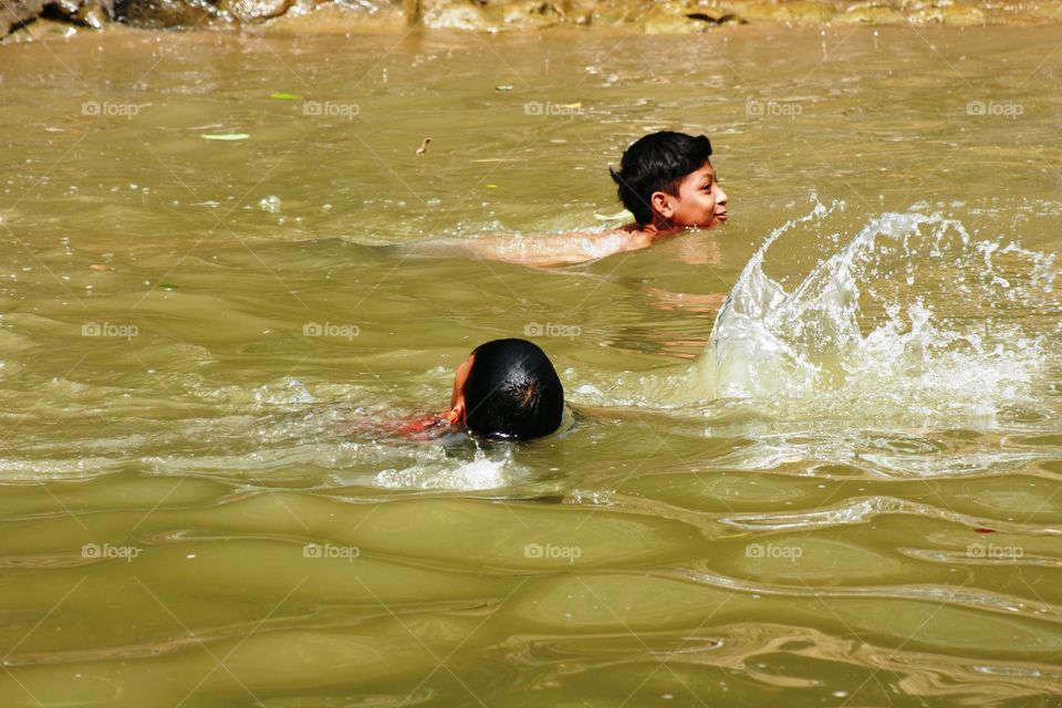 two kid play in river asian