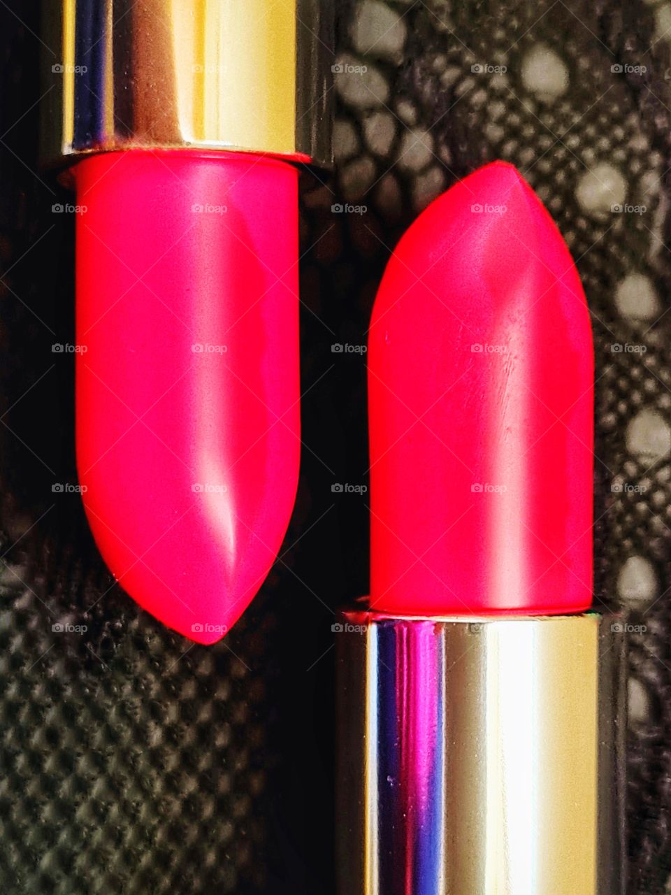 contrast of colors between two red lipsticks and the black background