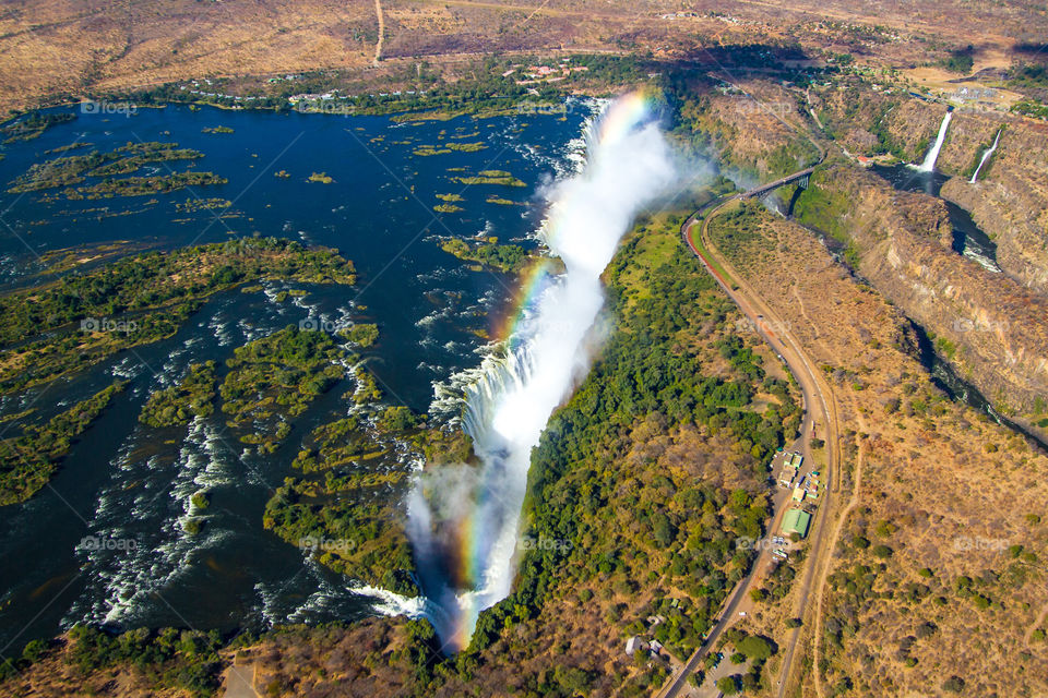 Aerial image of the Victoria Falls, one of the seven natural wonders of the world. The Vic falls forms the border between Zimbabwe and Zambia, Africa. The waterfall is the largest stretching 1708km (5604ft) and is 108m (354ft) high.