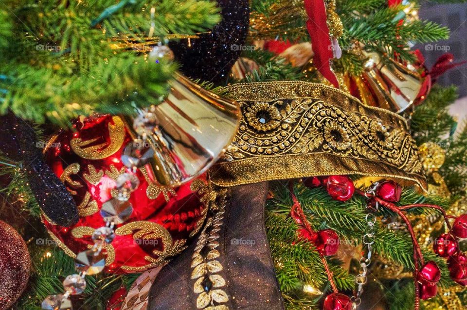 A close Christmas tree. A close up of a Christmas tree decorated with red and gold
