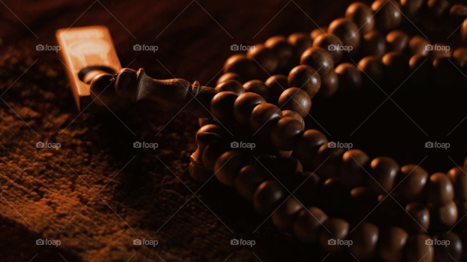 Wooden prayer beads in dim light