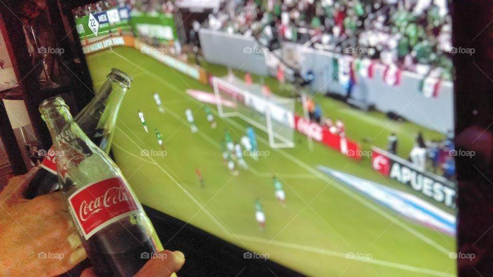 Enjoying the soccer game with Coca-Cola