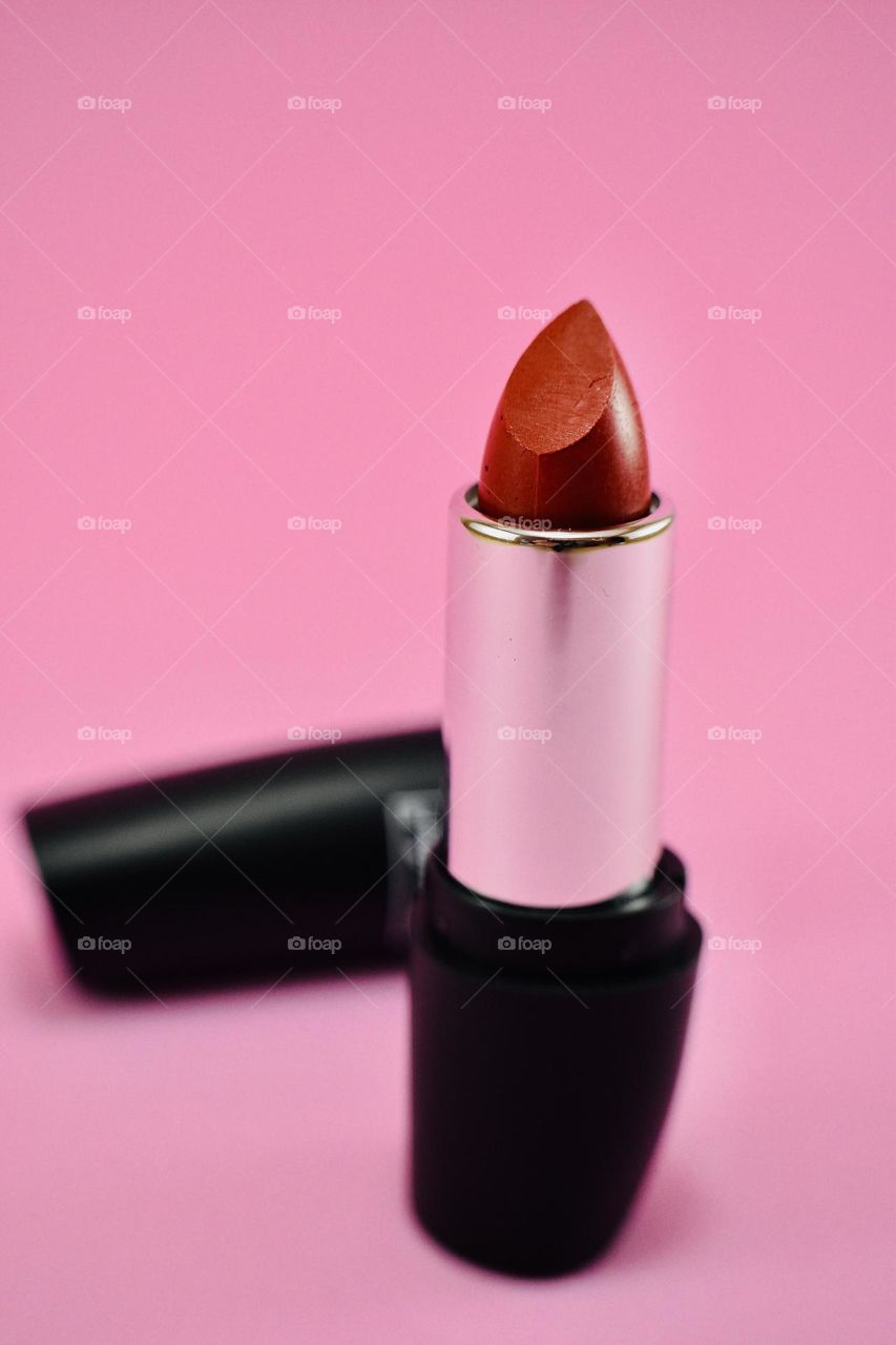 Red lipstick on pink background 