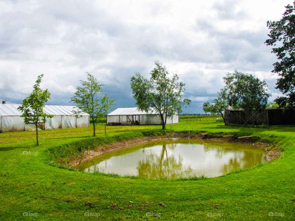 pond to the country house on a cloudy day