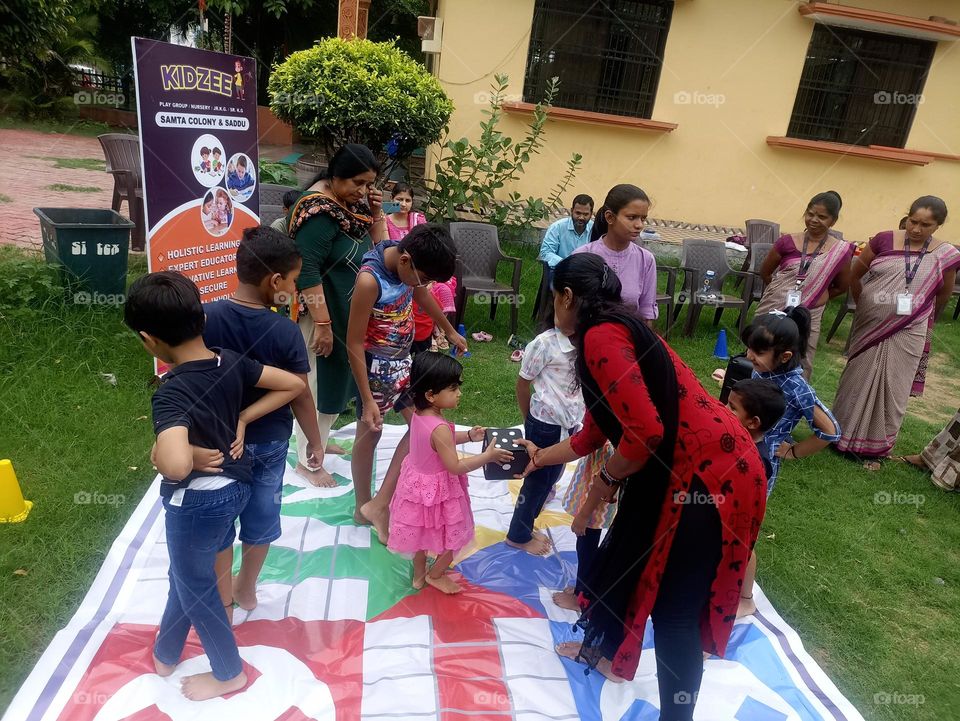 dice holding a child taking the help of her mother