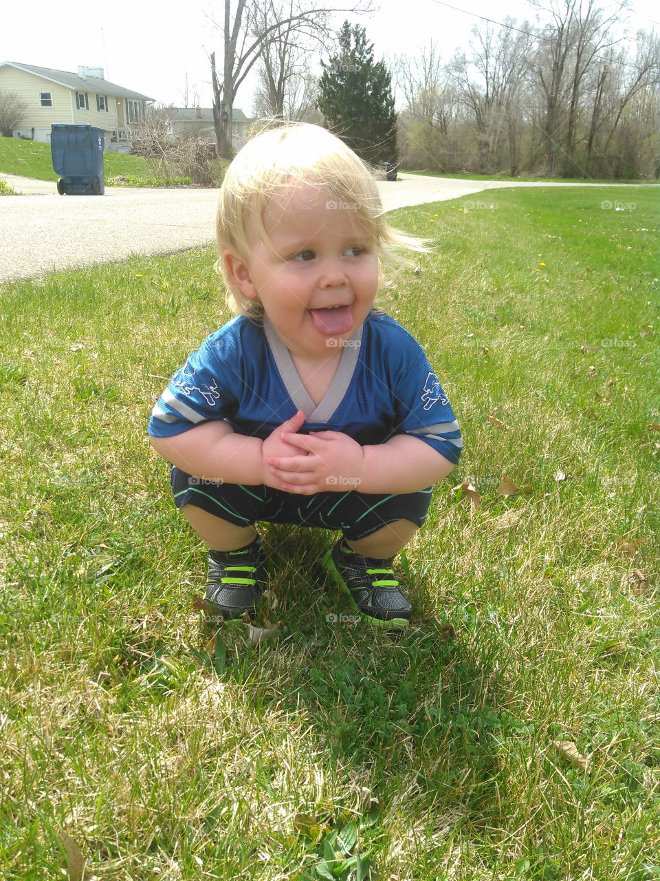 toddler totally posing for the camera
wearing Detroit lions t shirt