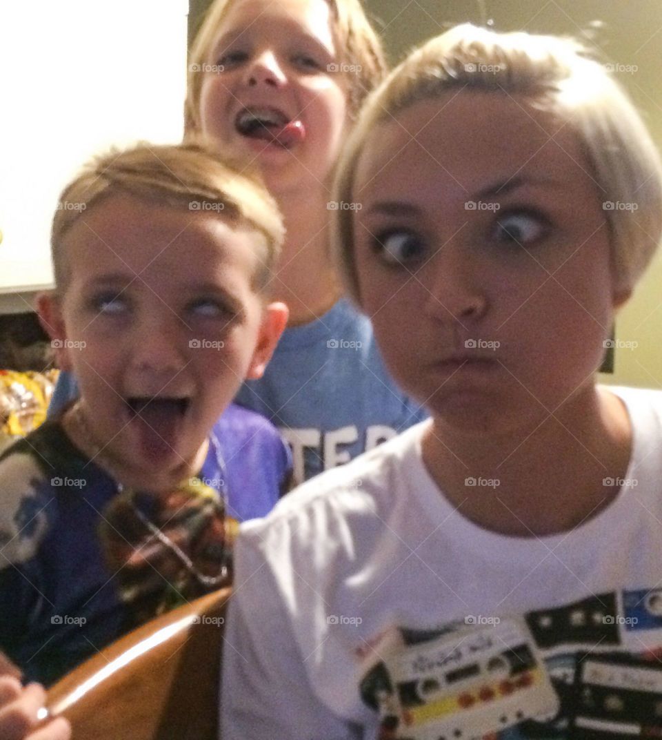 Siblings making funny faces