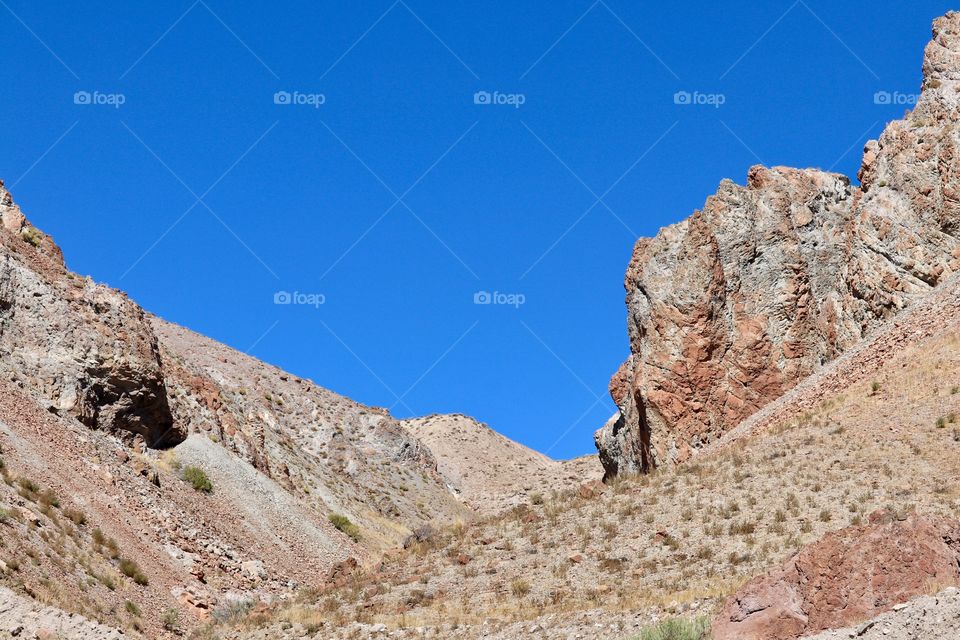 High Sierra Nevada Desert Mountains against a vivid clear blue sky suitable for wallpaper, desktop, background 