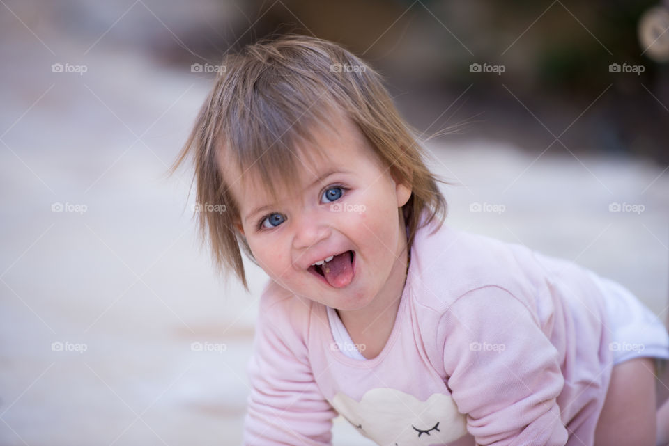 Cute baby with sticking out tongue