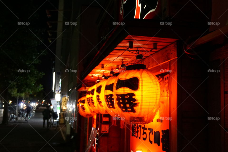 Orange lanterns marking the entrance to a local bar.