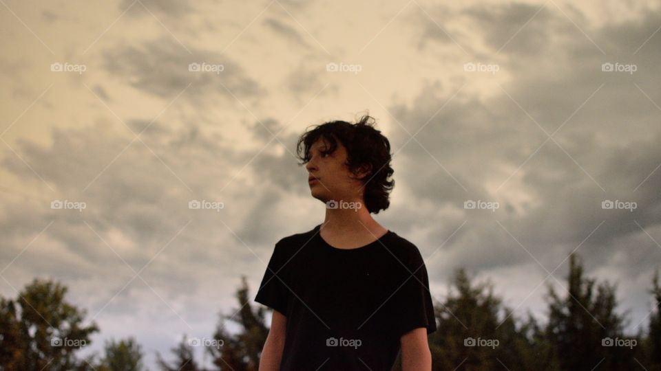 Thomas looking at the lightning with a bolt behind him