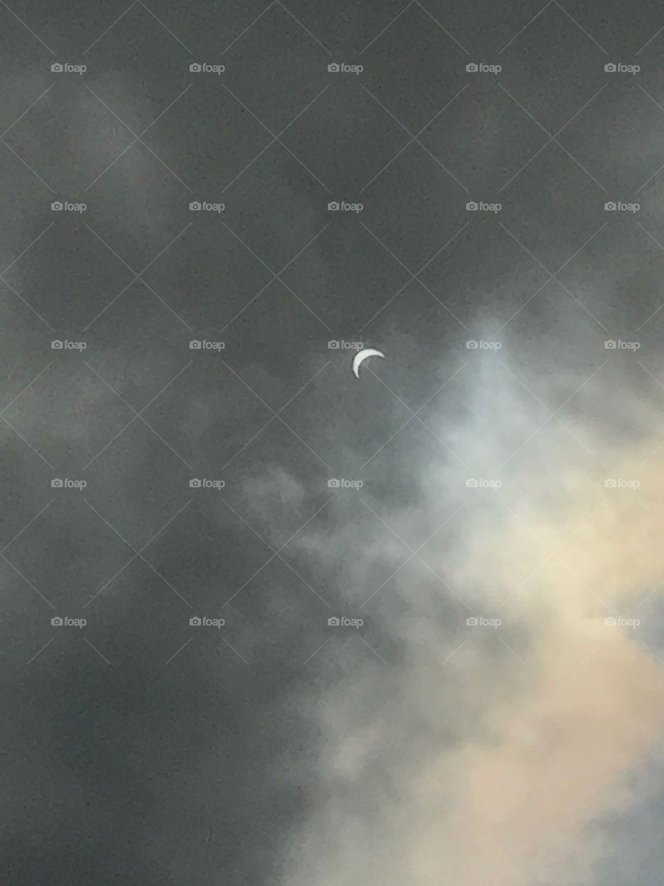 Solar eclipse on a cloudy day 