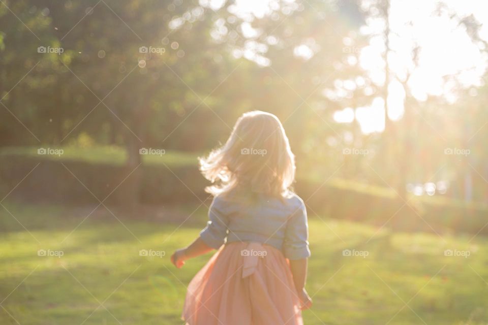 Lifestyle portrait of little girl from behind 