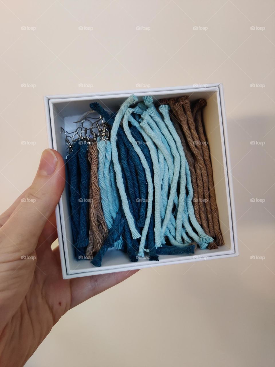 Pieces of a diy macrame earrings project