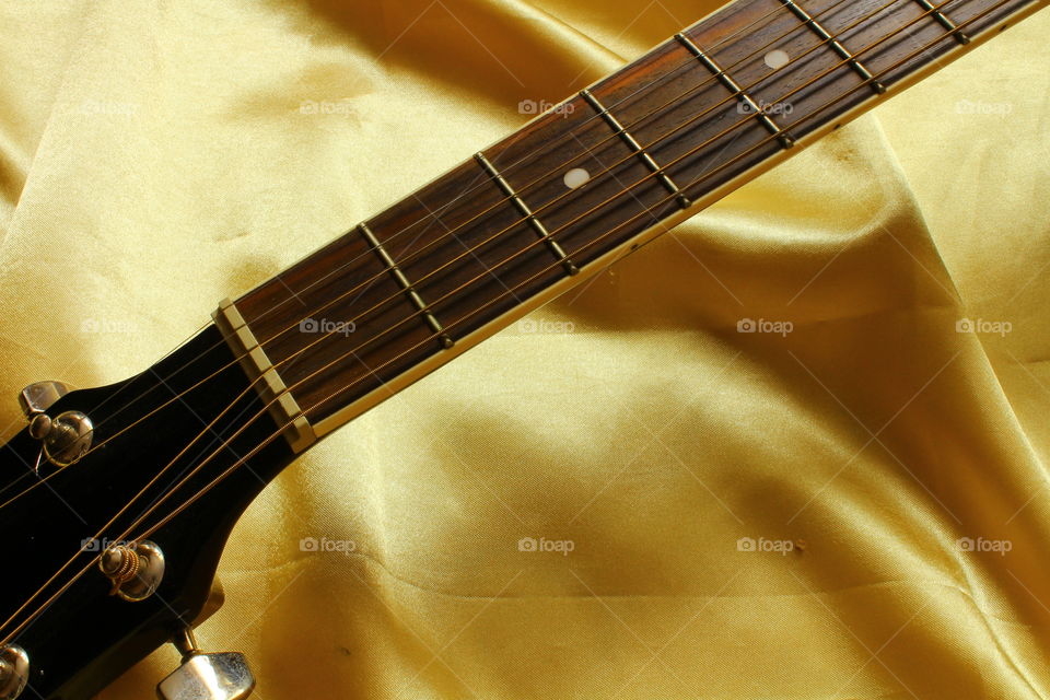 acoustic guitar on Golden textile