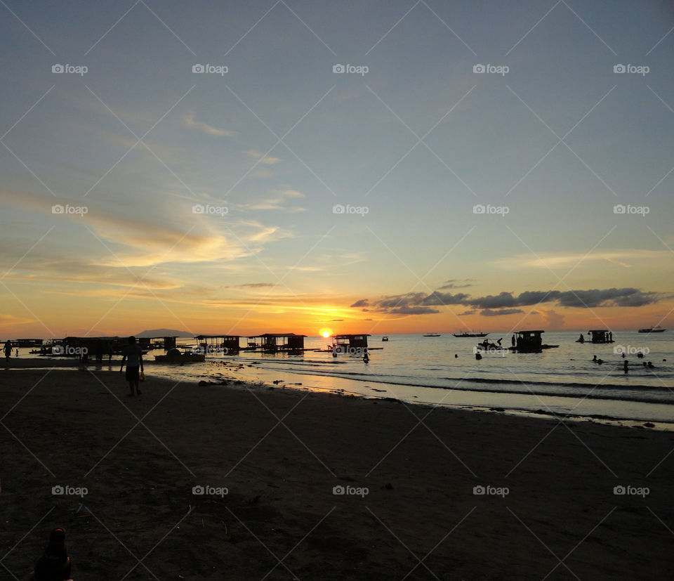 Scenic view of sea against orange sky