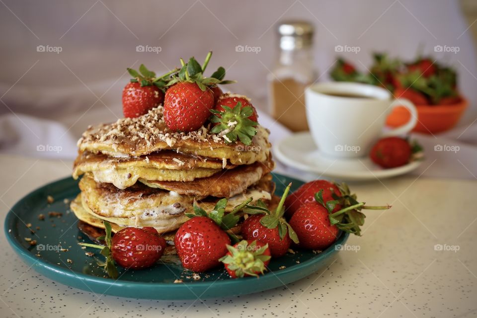 Pancakes with strawberry and cup of coffee 