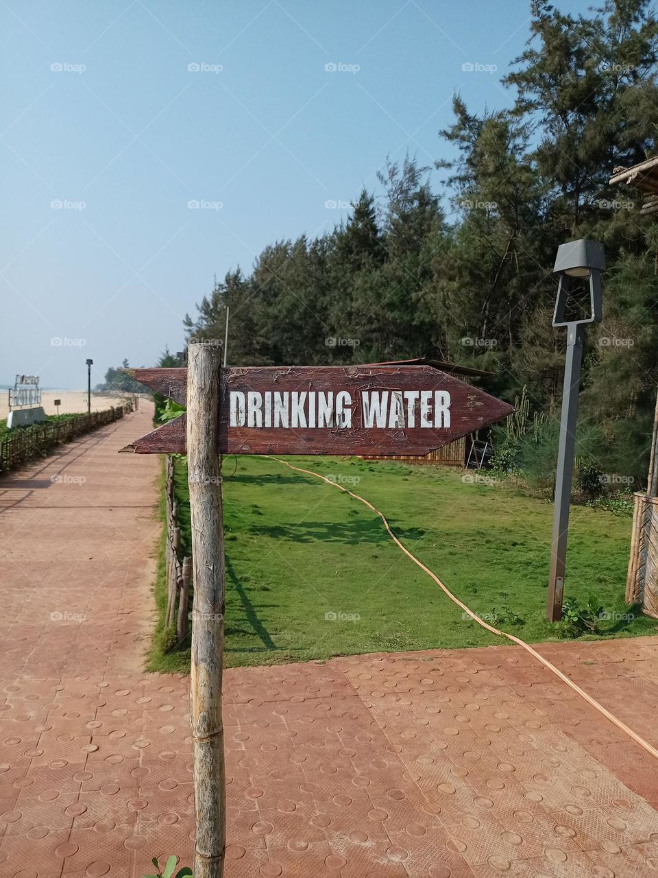 Drinking water sign on the beach with nice green colour background nature photography