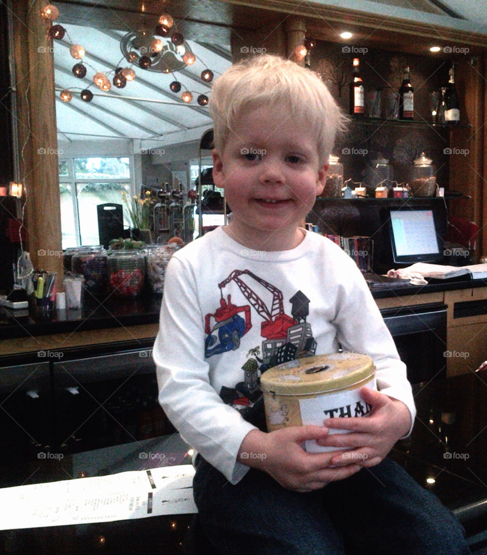 Happy young boy sitting at bar counter