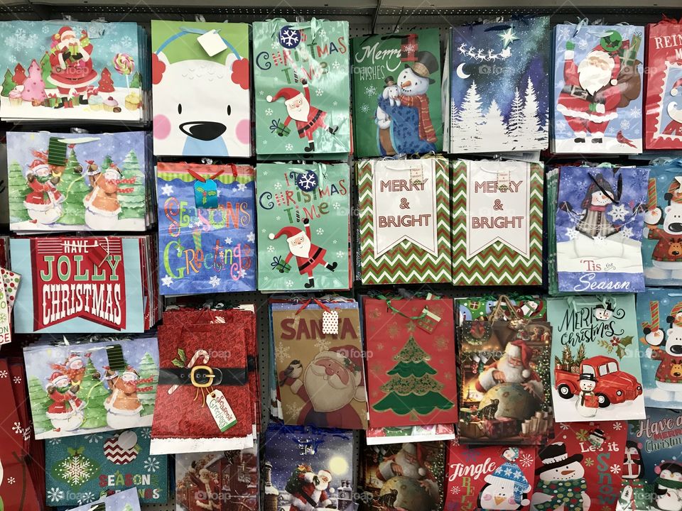Display of colorful, Christmas holiday gift bags on the store shelf. Wrapping presents and gifts for Christmas. USA, America 
