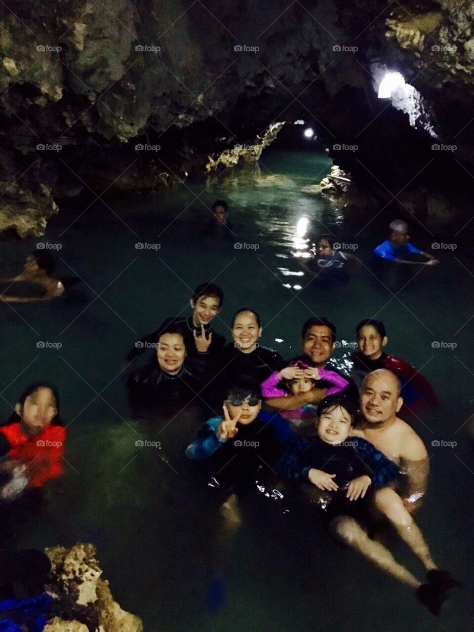 fathers and sons taking a swim inside the cave