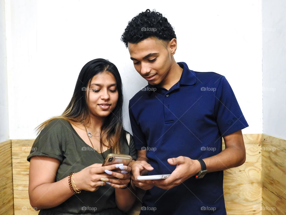 Guy And Girl Sharing Their Cellphones