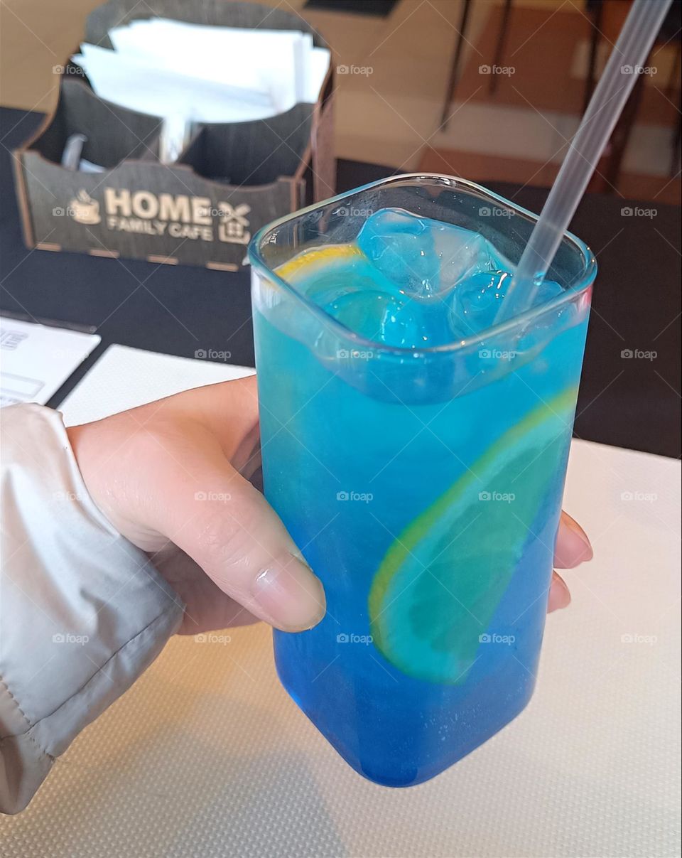 Cocktail with ice syrup, mint and lemon wedges